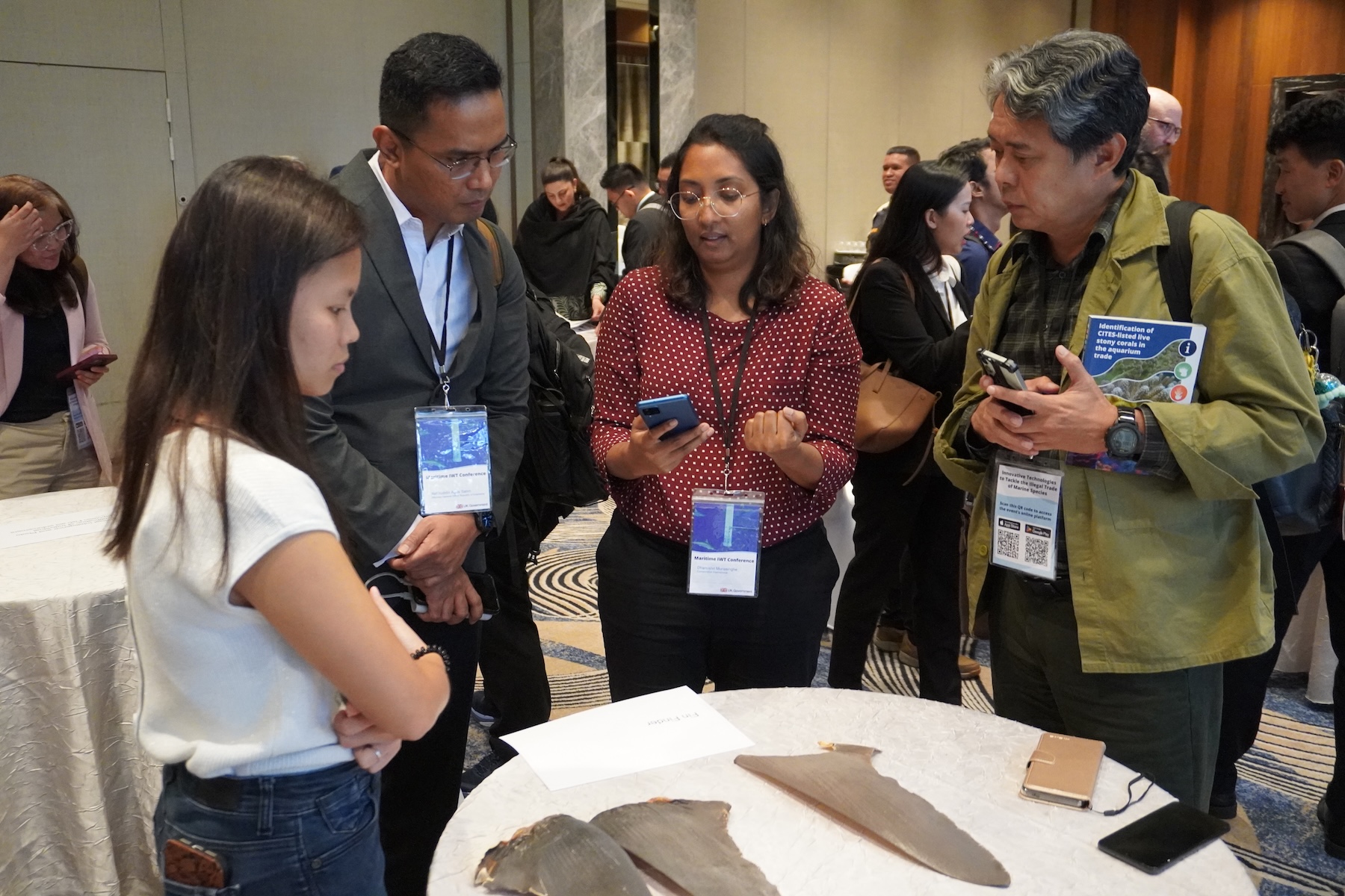 Conference attendees networking around a table during the Maritime IWT Conference.